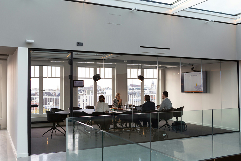4 people sat around a conference table
